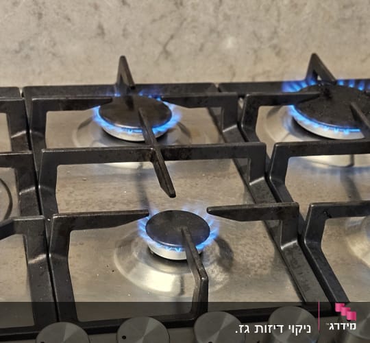 כיריים גז עם להבות כחולות במטבח מודרני